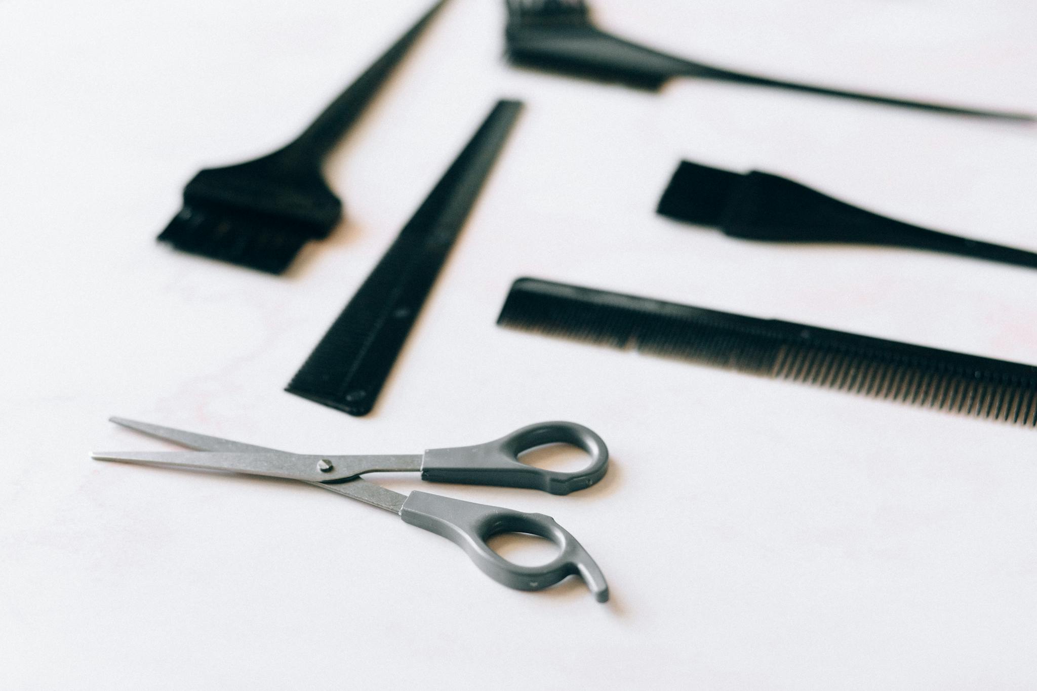 black handled scissors beside stainless steel scissors